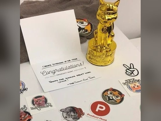 A Golden Kitty trophy beside a Product Hunt congratulations card for Chrome Extension of the Year, surrounded by stickers