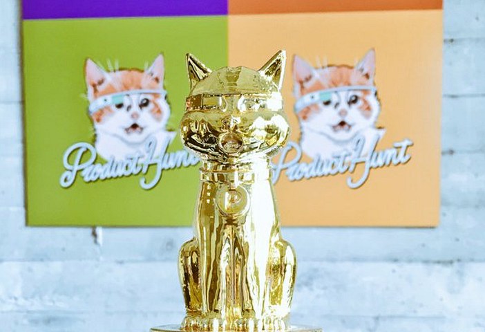 Golden Kitty trophy in front of Product Hunt posters